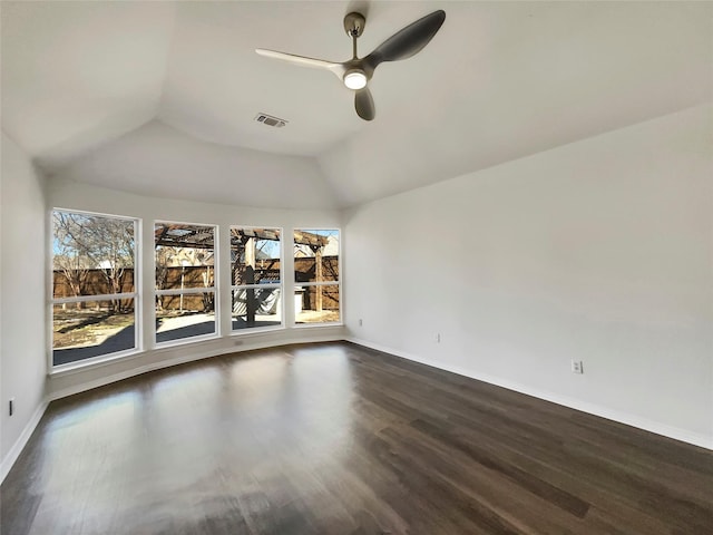 spare room with visible vents, dark wood finished floors, baseboards, lofted ceiling, and ceiling fan