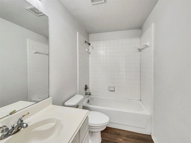 full bath with vanity, wood finished floors, visible vents,  shower combination, and toilet