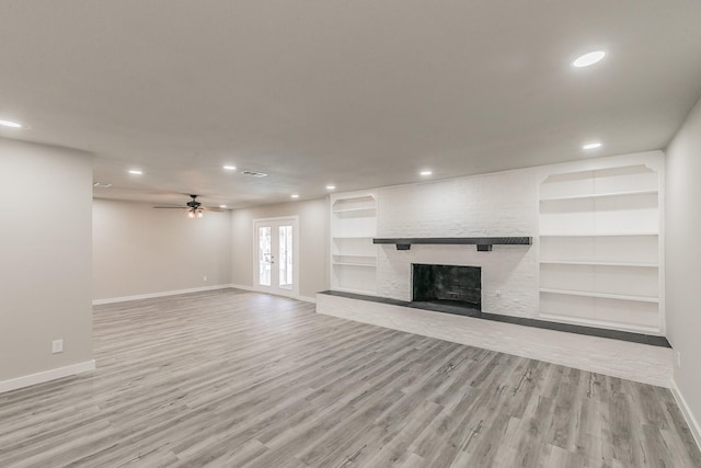 unfurnished living room with recessed lighting, wood finished floors, and baseboards
