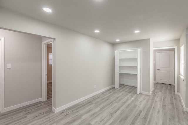 unfurnished bedroom featuring recessed lighting, light wood finished floors, and baseboards
