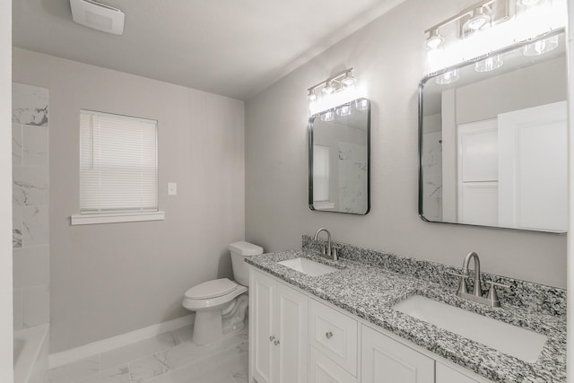bathroom featuring marble finish floor, baseboards, toilet, and a sink