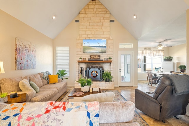 living room with visible vents, a large fireplace, high vaulted ceiling, and baseboards