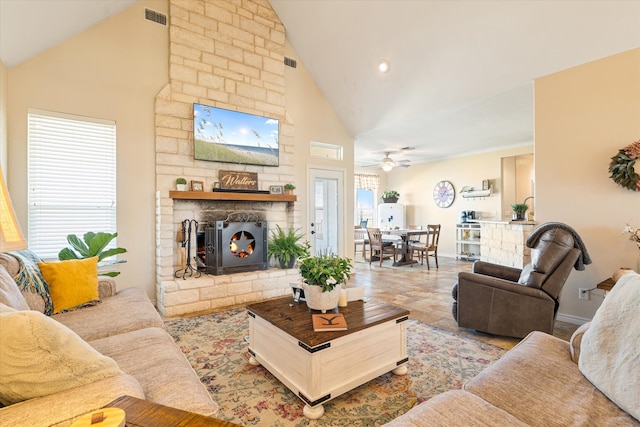 living area featuring visible vents, a fireplace, high vaulted ceiling, and baseboards