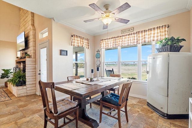 dining space with crown molding, stone finish floor, and baseboards