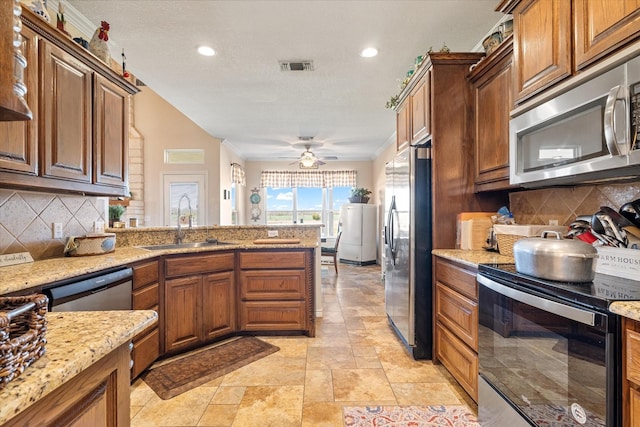 kitchen with a sink, visible vents, appliances with stainless steel finishes, and decorative backsplash