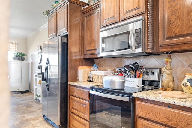 kitchen with light stone counters, stainless steel appliances, tasteful backsplash, and ornamental molding