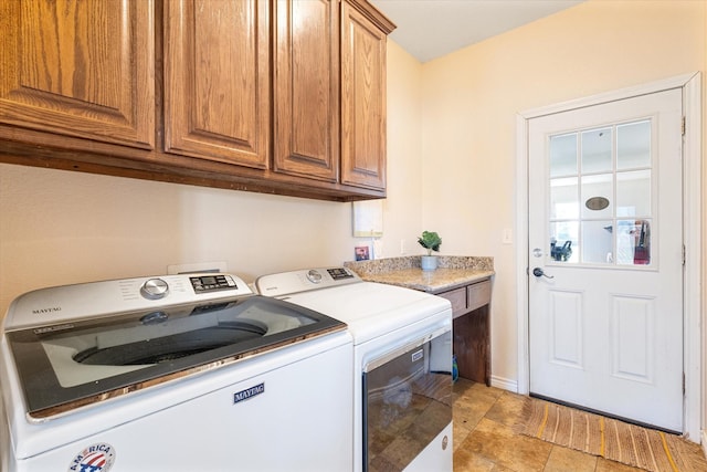 laundry area with cabinet space and separate washer and dryer