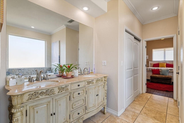 bathroom with tile patterned flooring, visible vents, ornamental molding, and a sink