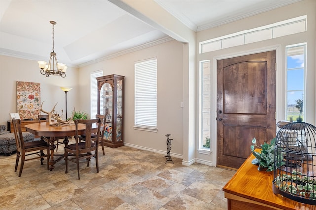 entrance foyer featuring an inviting chandelier, stone finish floor, baseboards, and ornamental molding