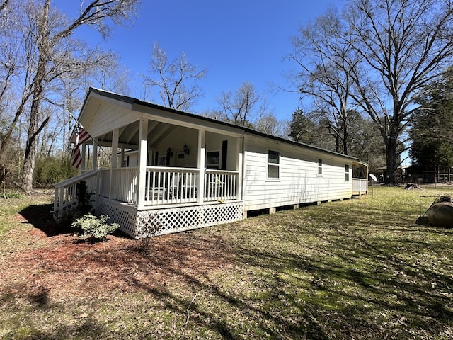 view of side of property featuring covered porch