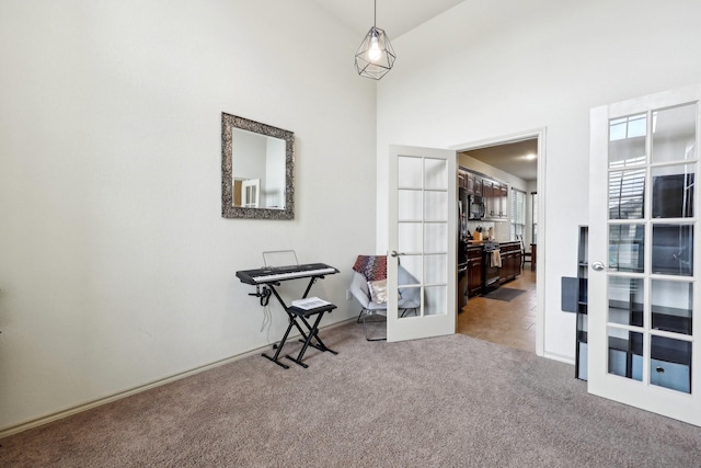 interior space with french doors and a towering ceiling