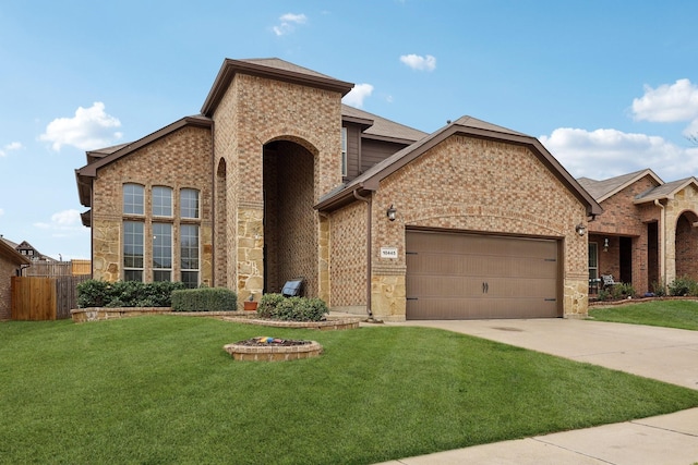 view of front of house with a front lawn, driveway, fence, a garage, and brick siding