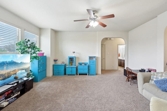 interior space with arched walkways and a ceiling fan