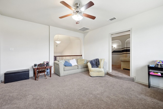 living area featuring visible vents, ceiling fan, and carpet floors