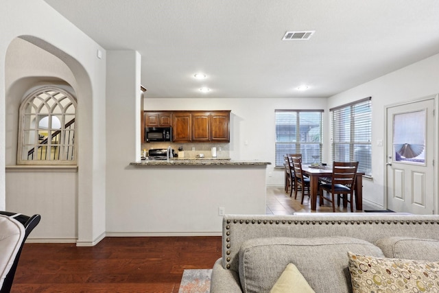 interior space with recessed lighting, wood finished floors, visible vents, and baseboards