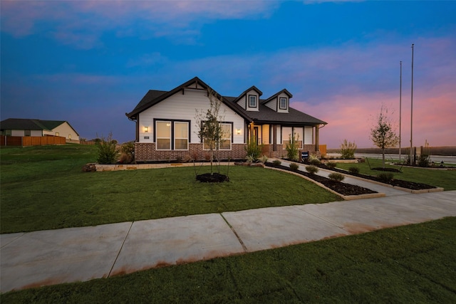 view of front of property with brick siding and a front yard