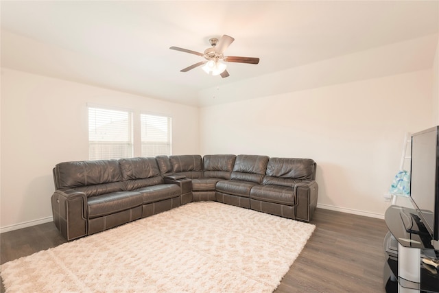 living room with vaulted ceiling, dark wood-style floors, baseboards, and ceiling fan