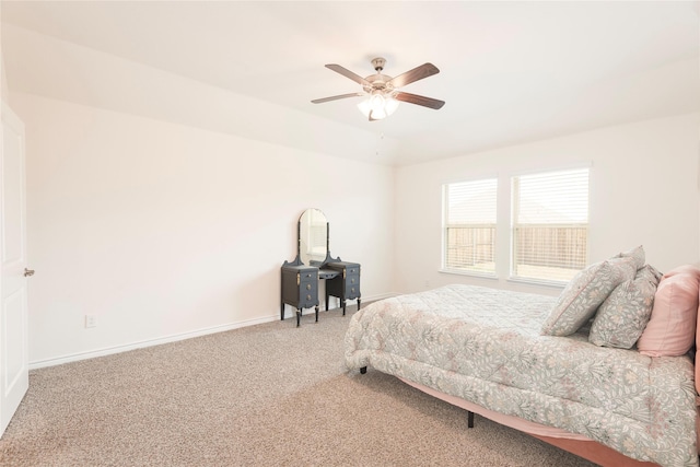 carpeted bedroom with a ceiling fan and baseboards