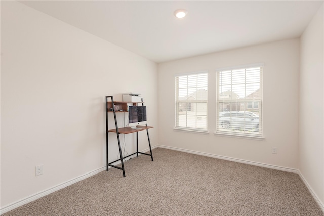 unfurnished room featuring carpet flooring and baseboards