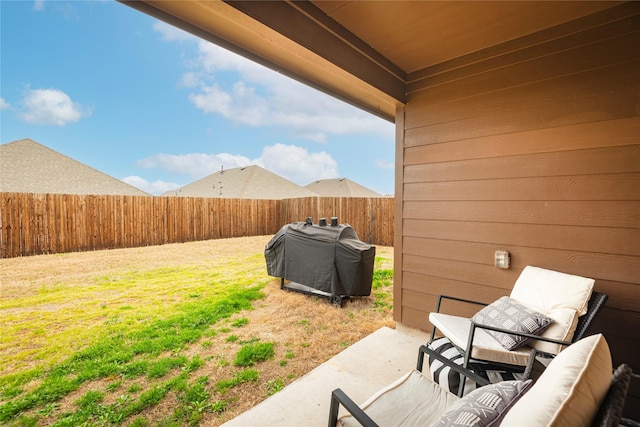 view of yard featuring a patio area, an outdoor living space, and a fenced backyard