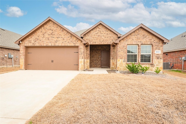 ranch-style house featuring a garage, brick siding, central AC, and concrete driveway