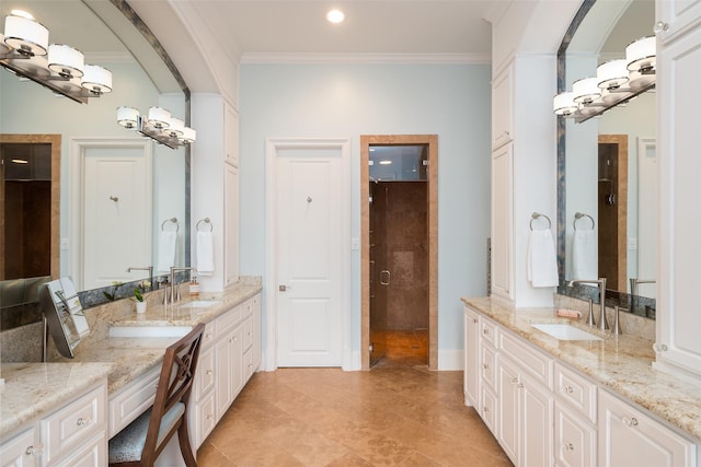 bathroom with crown molding, two vanities, and a sink