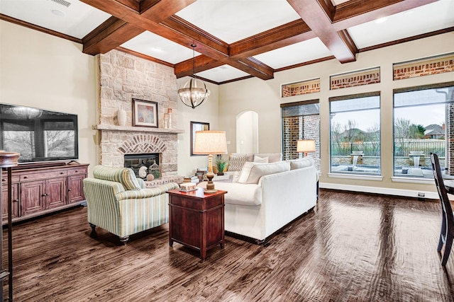 living area with beamed ceiling, coffered ceiling, a stone fireplace, and dark wood-style flooring