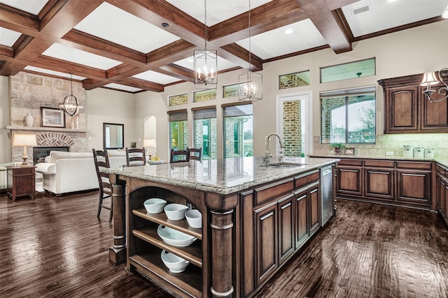 kitchen with visible vents, open shelves, a stone fireplace, dark wood-type flooring, and backsplash