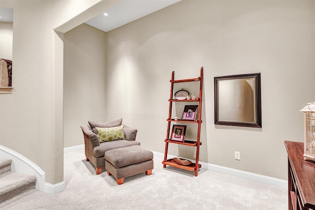 sitting room with baseboards and carpet floors