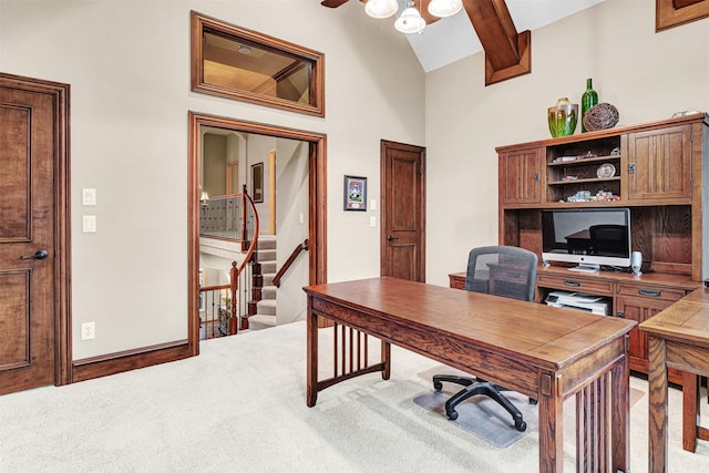 carpeted home office with baseboards, beam ceiling, high vaulted ceiling, and ceiling fan