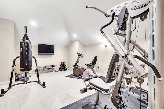 workout room with carpet floors, baseboards, and vaulted ceiling