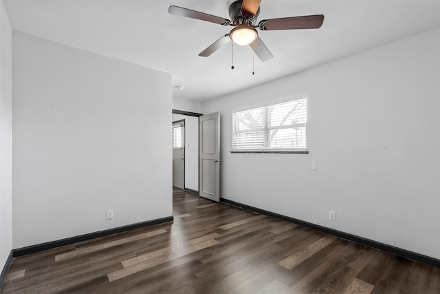 unfurnished room with wood finished floors, baseboards, and a ceiling fan