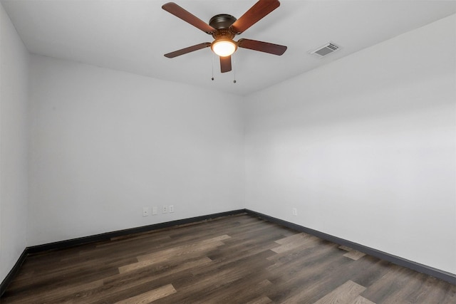 empty room with dark wood-type flooring, baseboards, and a ceiling fan