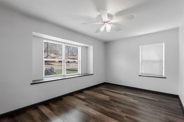 unfurnished room with ceiling fan, dark wood-style floors, and baseboards
