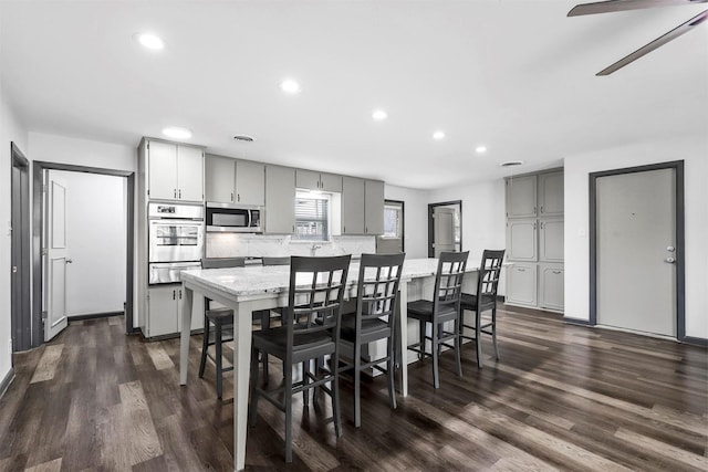 dining room with recessed lighting, dark wood-style flooring, and a ceiling fan