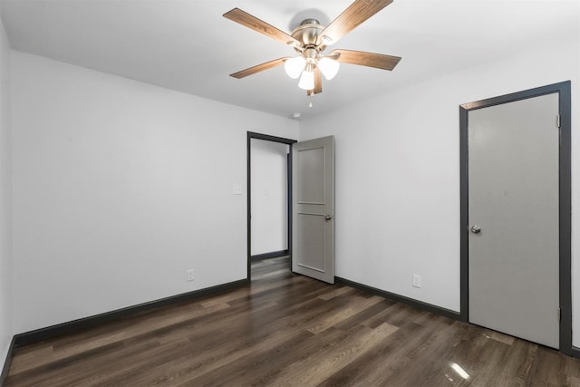 unfurnished bedroom featuring dark wood-style floors, baseboards, and ceiling fan