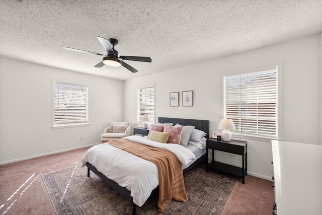 carpeted bedroom featuring baseboards, a textured ceiling, and a ceiling fan