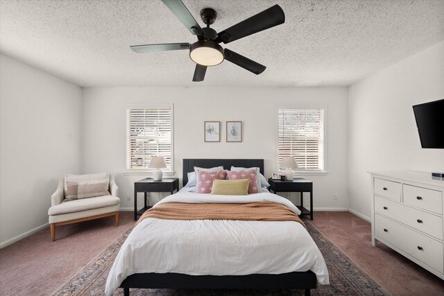 bedroom with dark carpet, a textured ceiling, a ceiling fan, and baseboards