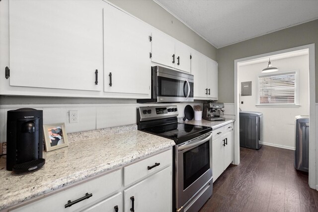 kitchen featuring washer / dryer, stainless steel appliances, dark wood-type flooring, a textured ceiling, and white cabinetry