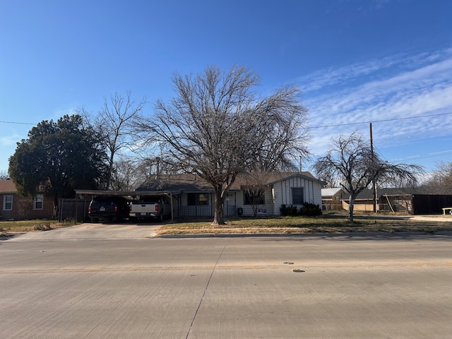 view of front facade with an attached carport and concrete driveway