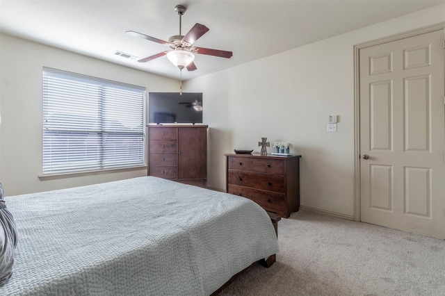 bedroom with carpet flooring, a ceiling fan, and visible vents