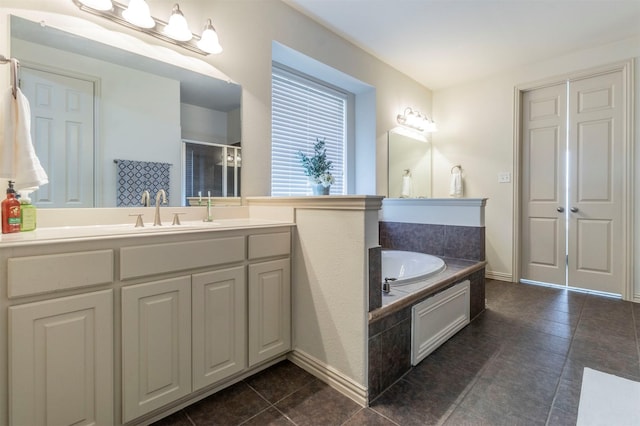 full bath with vanity, a garden tub, a shower stall, and tile patterned flooring