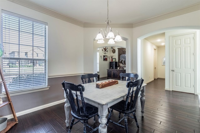 dining area with baseboards, dark wood finished floors, an inviting chandelier, arched walkways, and ornamental molding