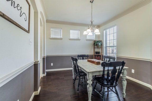 dining space with baseboards, a notable chandelier, dark wood-style flooring, and crown molding