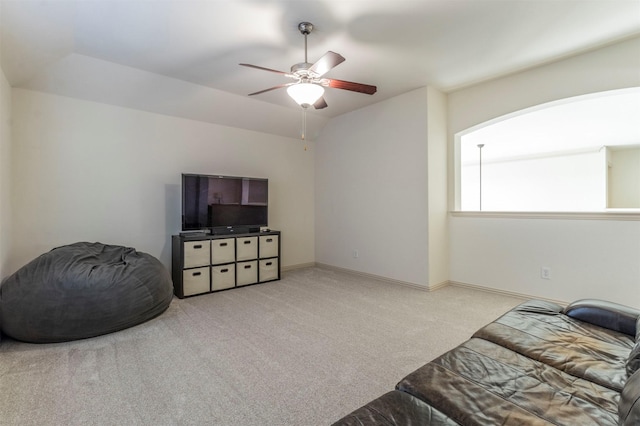 interior space featuring vaulted ceiling, baseboards, and ceiling fan