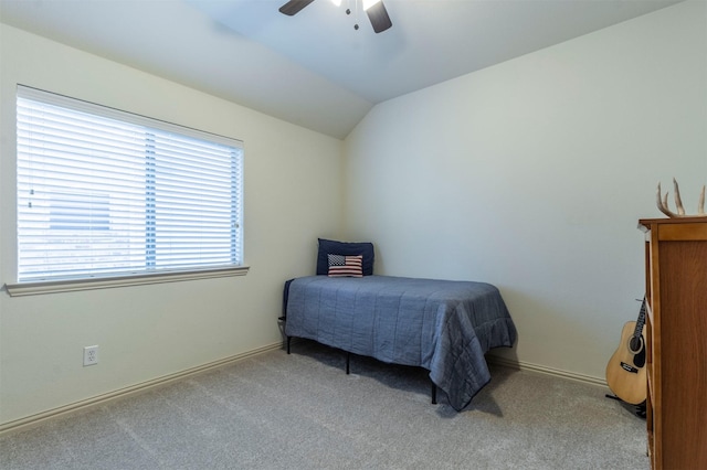 carpeted bedroom featuring baseboards, a ceiling fan, and vaulted ceiling