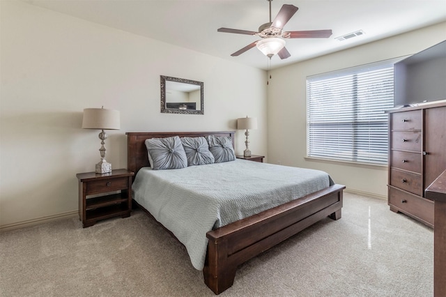 bedroom featuring visible vents, carpet floors, baseboards, and a ceiling fan