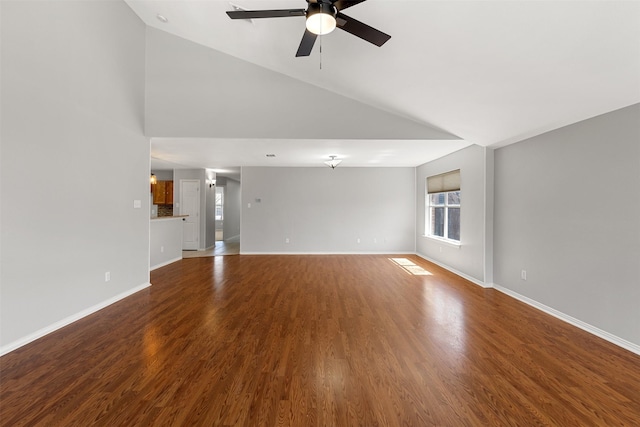 unfurnished living room featuring baseboards, ceiling fan, wood finished floors, and high vaulted ceiling