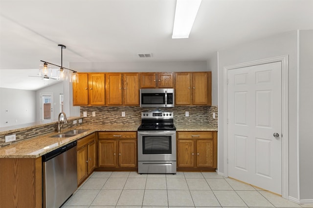 kitchen with brown cabinets, appliances with stainless steel finishes, and a sink