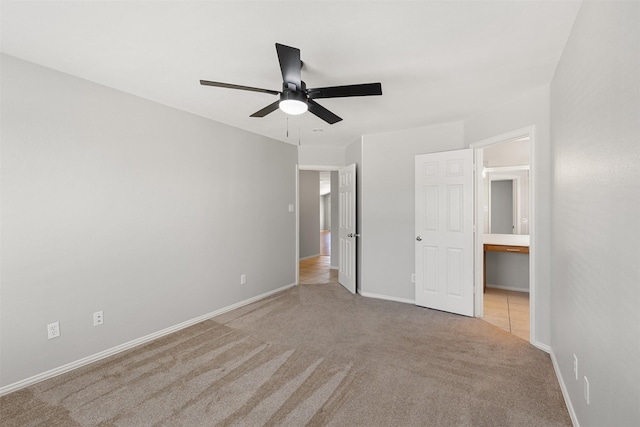 unfurnished bedroom featuring carpet floors, baseboards, and ceiling fan
